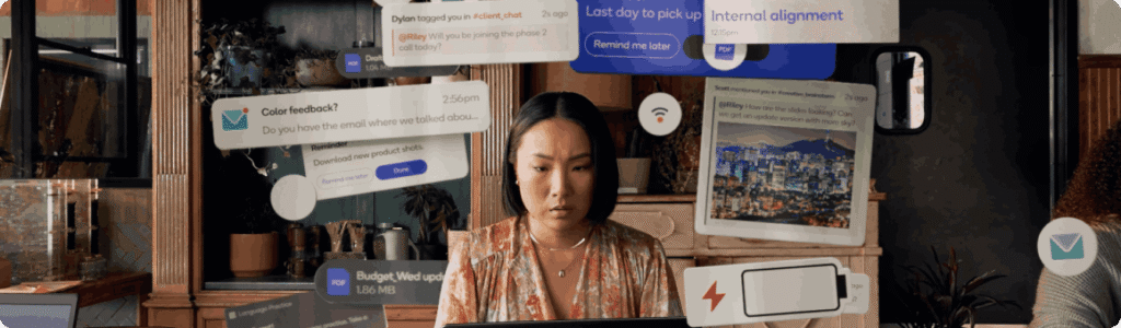 Professional woman at a desk with multiple digital notifications floating around, symbolizing online multitasking and digital marketing workflows.